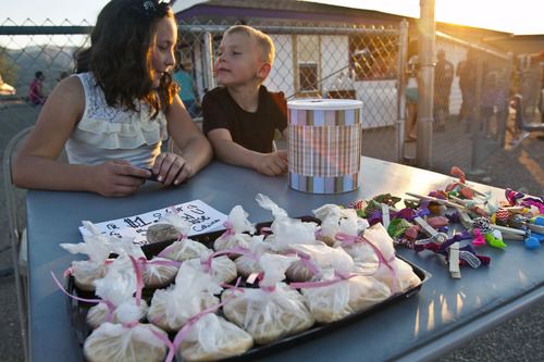Chris Detrick  |  The Salt Lake Tribune
Jessie Hirzel, 11, and Kade Nelson, 6, sell homemade sugar cookies and hair clips during a fundraiser at North Summit High School Thursday August 15, 2013. The Rockport 5 Fire is currently 25 percent contained.