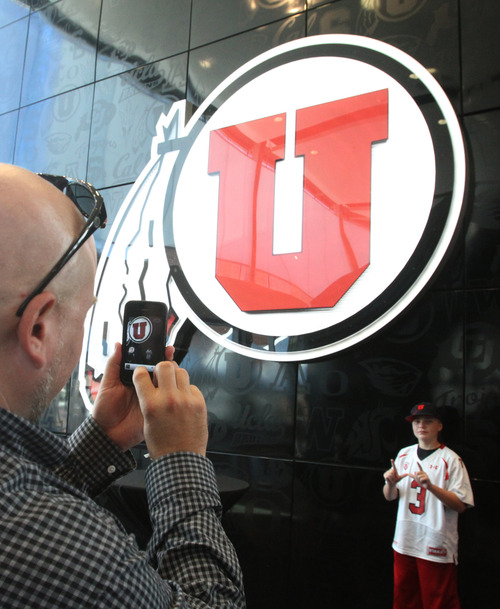 Rick Egan  | The Salt Lake Tribune 

Mason Heugly takes a photo of his son Dallas, 12, West Jordan, in the new Spence and Cleone Eccles Football Center, Thursday, August 15, 2013.