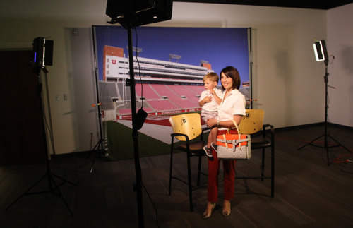 Rick Egan  | The Salt Lake Tribune 

Kristine Eccles checks out the photo studio in the new Spence and Cleone Eccles Football Center with her 2-year-old son Spencer, Thursday, August 15, 2013.