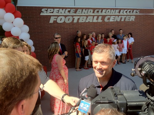 Rick Egan  | The Salt Lake Tribune 
Spence Eccles poses with his family in front of the new Spence and Cleone Eccles Football Center after the ribbon cutting, while coach Kyle Whittingham speaks to the media, Thursday, August 15, 2013.