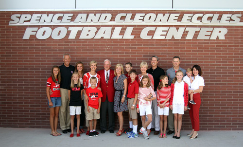 Rick Egan  | The Salt Lake Tribune 

Spence Eccles poses with his family in front of the new Spence and Cleone Eccles Football Center after the ribbon cutting, Thursday, August 15, 2013.