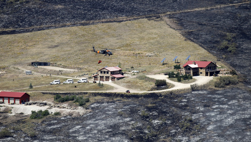 Al Hartmann  |  The Salt Lake Tribune
Fire from the Rockport 5 fire burned ccompletely around property in the Rockport Estates that had a sprinkler system that wet down the yard to maintain a defensible perimiter.