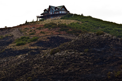 Chris Detrick  |  The Salt Lake Tribune
A home above the charred mountainside from the Rockport 5 Fire Friday August 16, 2013.