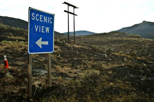Chris Detrick  |  The Salt Lake Tribune
Burned mountainside off SR 32 just east of Wanship. Scenic sign is for a view of Rockport Reservoir across the road Friday August 16, 2013.