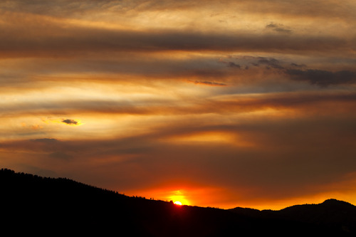 Chris Detrick  |  The Salt Lake Tribune
With smoke from wildfires in the air, the sun sets over Park City Friday August 16, 2013.