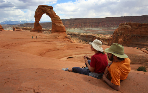 Francisco Kjolseth  |  The Salt Lake Tribune
Mindy and Colby Tueller take in the beauty of one of Utah's most famous icons following their 1.5-mile trek to Delicate Arch in Arches National Park in late May.