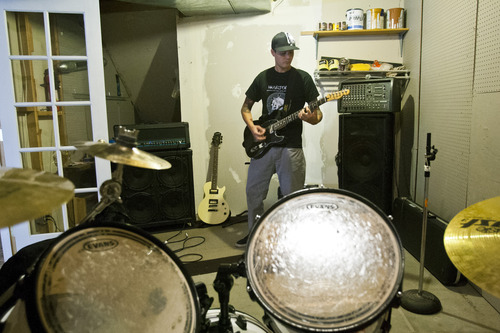 Chris Detrick  |  The Salt Lake Tribune
Josh Leland plays the guitar at his home in South Jordan Wednesday July 31, 2013. leland
