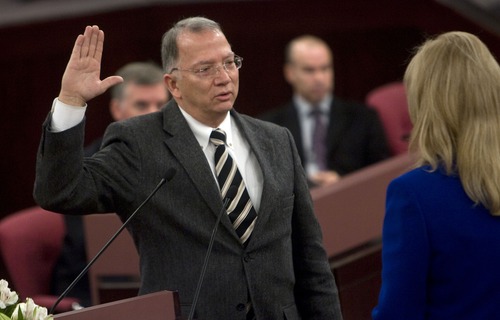 Tribune file photo by Al Hartmann
Salt Lake County Assessor Lee Gardner, seen here in 2011 taking the oath of office for a fifth time, is leaving the county Aug. 31 with one year left in his term to go on an LDS Church mission.