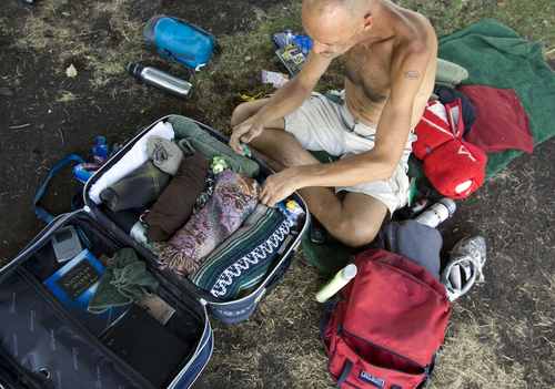 Keith Johnson | The Salt Lake Tribune

Kevin Tetreault organizes his belongings at Pioneer Park in Salt Lake City, August 19, 2013. Kevin is one of the many homeless that populate Pioneer Park during the day and often at night.