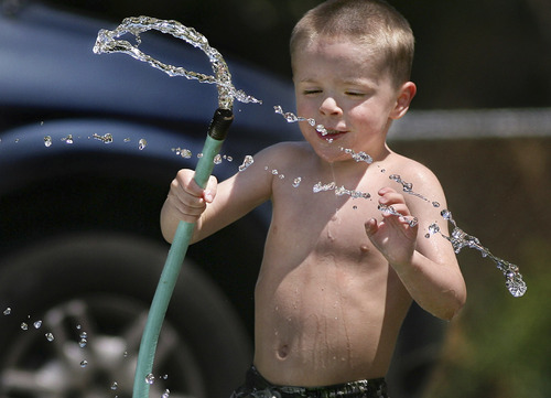 Scott Sommerdorf  |  Tribune file photo
Fees for water and sewer users are likely to go up under new fees being proposed by the state to run environmental programs that are not being fully funded by the federal and state governments. In this 2008 photo, then-4-year-old Joshua Beacham plays in the front yard of his North Park Provo home and cools off with the water hose.