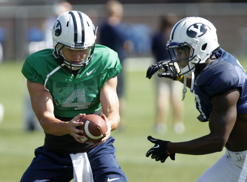 Al Hartmann  |  The Salt Lake Tribune
Quarterback Taysom Hill hands off the ball during BYU's third session of fall camp Tuesday August 6.