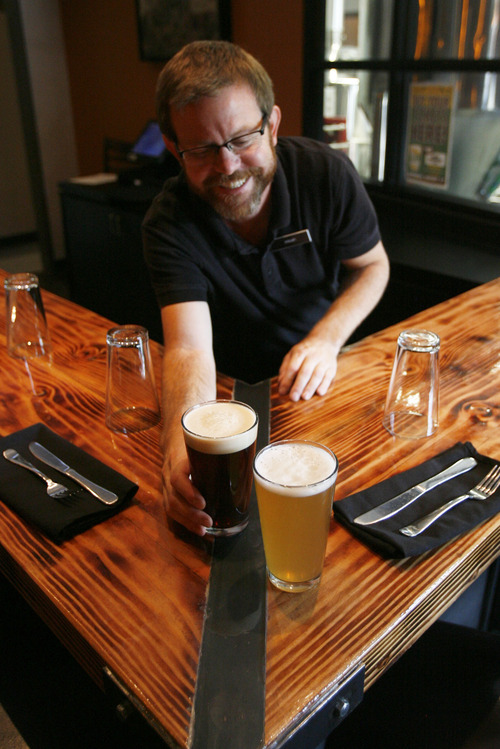 Francisco Kjolseth  |  The Salt Lake Tribune
Server Micah Tordiff of the Avenues Proper Restaurant & Publick House serves up a glass of Leipziger Gose and Irish Red Ale made in small-batches at the restaurant in the Avenues at 376 8th Ave.