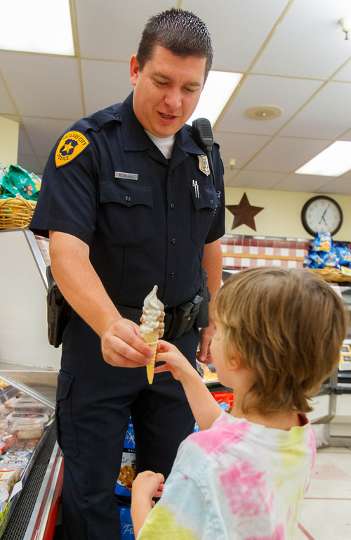 Trent Nelson  |  The Salt Lake Tribune
Detective Brandon Shearer hands out ice cream cones to citizens while doing community outreach in Salt Lake City, Thursday July 25, 2013.