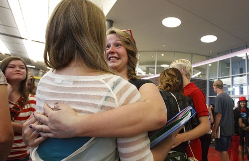 Leah Hogsten | The Salt Lake Tribune
Ninth-grader Madison Tagge (right) bear hugs her friend Mikala Gehlen on their first day at Granger High School. Granger High School welcomed returning students and 1,500 new students with a red carpet welcome, lined by cheering school ambassadors and teachers, Wednesday, August 21, 2013.