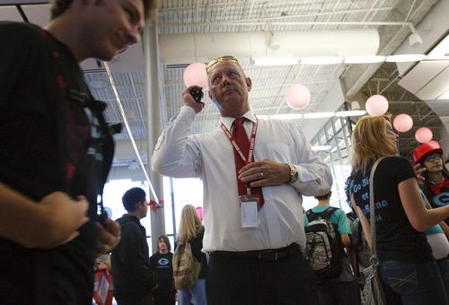 Leah Hogsten | The Salt Lake Tribune
Granger High School Principal Jerry Haslam directs traffic on the first day of school. Granger High School welcomed returning students and 1,500 new students with a red carpet welcome, lined by cheering school ambassadors and teachers, Wednesday, August 21, 2013.