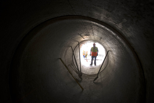 Paul Fraughton  |   The Salt Lake Tribune
A worker looks into a section of the Parley's Danyon culvert project, which is halfway complete. When finished, the pipe will stretch for two miles down the canyon.    Wednesday, August 21, 2013