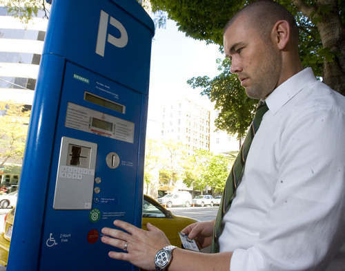 Paul Fraughton  |   The Salt Lake Tribune
Chad Golsan, of Salt Lake City, goes through the steps to pay for parking at a parking kiosk on Main Street. A new opinion poll says a majority of those surveyed like the kiosks and find them easy to use. Wednesday, August 21, 2013
