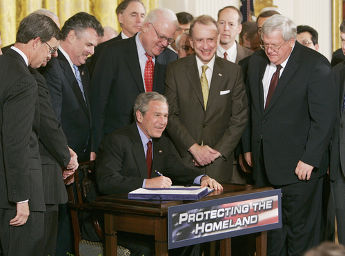 President Bush surrounded by members of Congress takes part in a signing ceremony for the USA Patriot and Terrorism Prevention Reauthorization Act, Thursday, March 9, 2006, in the East Room at the White House in Washington. After a long battle with Congress that went down to the wire Bush signed a renewal of the USA Patriot Act, a day before 16 major provisions of the old law expire.      (AP Photo/Ron Edmonds)