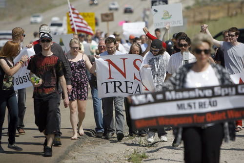 Francisco Kjolseth  |  The Salt Lake Tribune
Opponents of the NSA Data Center protest the center on the 4th of July, by marching up to the Intersection of NSA Data Center access road and Redwood Road across from Camp Williams.