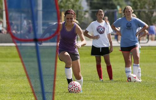 Steve Griffin | The Salt Lake Tribune

Spanish Fork soccer player McKinley Brinkerhoff is off to a flying start this year scoring three goals in the school's season opener. She scored 42 goals last season. Here she works on drills during practice at the Spanish Fork., Utah school Aug. 20, 2013.
