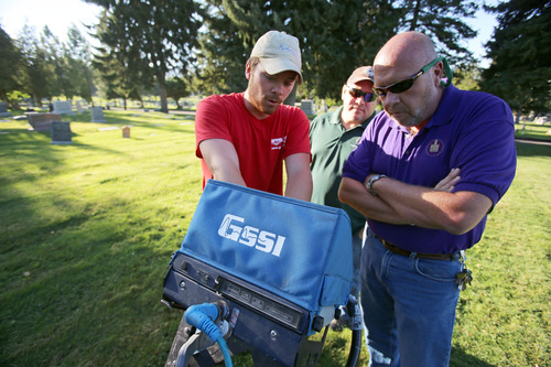 Francisco Kjolseth  |  The Salt Lake Tribune
Adam Kubicki, a ground penetrating radar technician, left, points out the things he looks for when using a 400 MHz antenna with field crew manager Curtis Atkins, center, and Mark Smith, right, with the Salt Lake City Cemetery on Wednesday. The search was on for famous Western gunslinger Jack Slade buried in 1864. Slade was famous for protecting stage coach routes between eastern and western U.S. and was also a drunk who was lynched for disturbing the peace in Montana, before being buried in the Avenues Cemetery. A historian believes his grave is in a 16-by-16 foot plot there, and he is attempting to dig up the body and move it to Slade's home in Illinois.