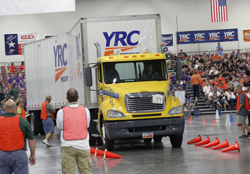 Al Hartmann  |  The Salt Lake Tribune
Judges watch carefully as a twin trailer driver eases his rig through the "Diminishing Alley" part of the driving course to test his skill inside the Salt Palace Convention Center for the American Trucking Association National Truck Driving Championships in which 424 of the best professional truck drivers from around the country competed in nine different truck classes.