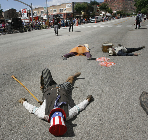 Rick Egan   |  The Salt Lake Tribune

Western Characters lie dead on Main street in Kanab, after a gun battle,  during the Western Legends Round Up Saturday August 28, 2010.
