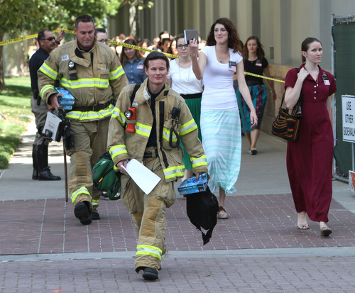 Rick Egan  |  The Salt Lake Tribune 
LDS Church sister missionaries are evacuated from Temple Square to be checked out by emergency personnel after toxic fumes were accidentally released in the South Visitors Center at Temple Square, Thursday, August 22, 2013.