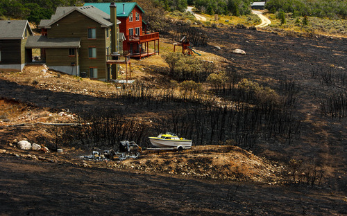 Trent Nelson  |  The Salt Lake Tribune
Homes spared from the fire in the Lake Rockport Estates, Thursday August 22, 2013. A Utah program requires new construction to reduce brush and trees around houses. This fuels mitigation strategy creates a defensible space so that wildfires have a decreased chance of burning structures.