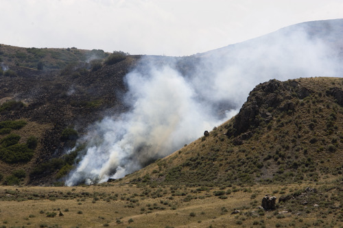 Rick Egan  |  The Salt Lake Tribune 
A grass fire in the Rosecrest area of Herriman burns, Saturday, August 24, 2013.