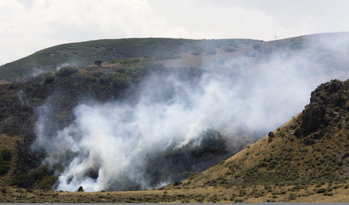 Rick Egan  | The Salt Lake Tribune 

A wildfire in the Rosecrest area of Herriman burns, Saturday, August 24, 2013.