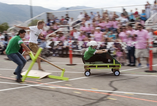 Steve Griffin | The Salt Lake Tribune

Clearfield High School students Chasen Robbins and Seth Bingham dodge debris as the pallet racer carrying Clearfield High School janitor Jeff Weston, right,  heads out of control, into the crowd during the fifth annual Pallet Grand Prix in the Layton Hills Mall parking lot Friday Aug. 23, 2013. Robbins and Bingham were able to stop the vehicle before it crashed into the crowd.