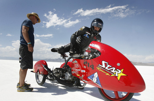 Scott Sommerdorf  |  The Salt Lake Tribune
Matt Inscho, left, watches as Dan Parker, a race car driver who lost his sight last year in an accident, gets on his motorcycle for practice runs on the Bonneville Salt Flats, Sunday, August 25, 2013.