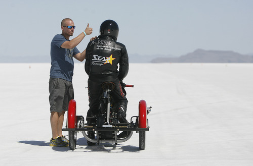 Scott Sommerdorf  |  The Salt Lake Tribune
Crew member Matt Inscho gives the thumbs-up to the chase vehicle as Dan Parker, a race car driver who lost his sight last year in an accident, is ready to go out on a practice run on the Bonneville Salt Flats, Sunday, August 25, 2013.