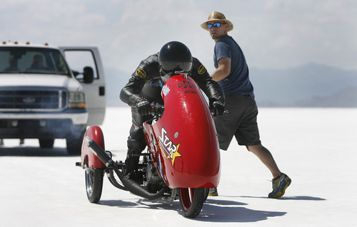 Scott Sommerdorf  |  The Salt Lake Tribune
Matt Inscho takes a last look back as Dan Parker, a race car driver who lost his sight last year in an accident, is about to take his motorcycle out for a practice run on the Bonneville Salt Flats, Sunday, August 25, 2013.