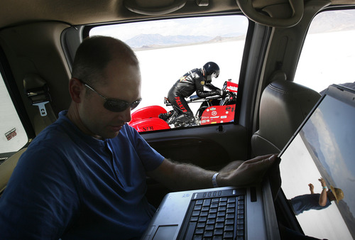 Scott Sommerdorf  |  The Salt Lake Tribune
Engineer Patrick Johnson checks the readouts on Dan Parker's racing motorcycle just prior to test runs on the Bonneville Salt Flats, Sunday, August 25, 2013.