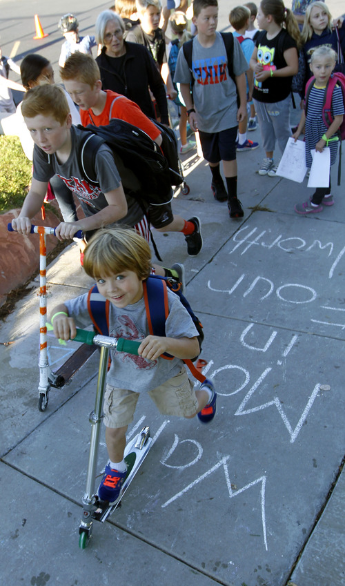 Al Hartmann  |  The Salt Lake Tribune
Students walk, bike and scooter to Dilworth Elementary School at 1953 S. 2100 East in Salt Lake City Wednesday August 28.  
The Utah Department of Transportation kicked off an annual statewide safe walking and biking to school challenge called "Walk More in Four." Parents and kids enjoyed a pep rally and signed a safety pledge promising to walk or bike to school at least three days a week.