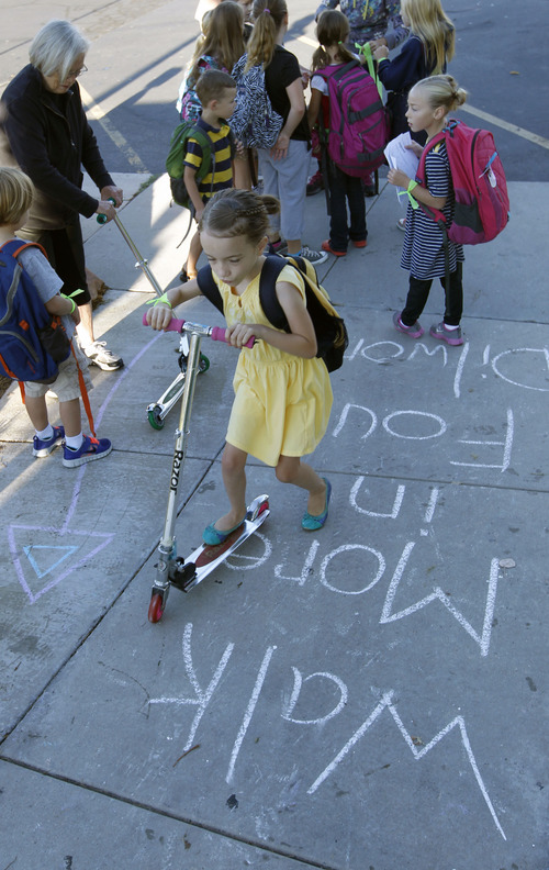 Al Hartmann  |  The Salt Lake Tribune
Students walk, bike and scooter to Dilworth Elementary School at 1953 S. 2100 East in Salt Lake City Wednesday August 28.  
The Utah Department of Transportation kicked off an annual statewide safe walking and biking to school challenge called "Walk More in Four." Parents and kids enjoyed a pep rally and signed a safety pledge promising to walk or bike to school at least three days a week.