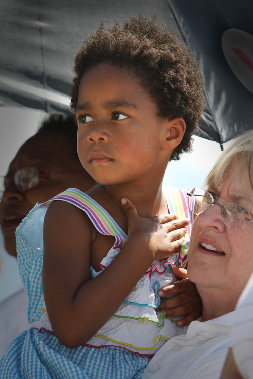 Rick Egan  | The Salt Lake Tribune 

Ellen Mitchell holds her granddaughter, Meg Hogland, 4, as they listen to the Calvary Baptist Church Choir sing at the celebration of the 50th anniversary of Dr. Martin Luther King Jr.'s "I Have a Dream" speech, Wednesday, August 28, 2013.