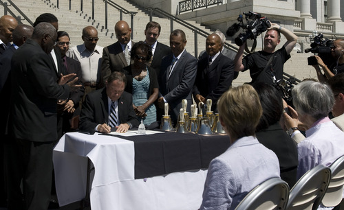Rick Egan  | The Salt Lake Tribune 

Gov. Gary Herbert signs an executive order for the Martin Luther King Jr. Human Rights Commission at the celebration of the 50th anniversary of Dr. Martin Luther King Jr.'s "I Have a Dream" speech, at the Utah State Capitol, Wednesday, August 28, 2013.