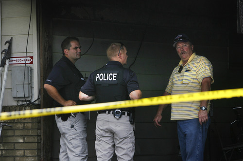Scott Sommerdorf   |  The Salt Lake Tribune
Tooele Police examine the aftermath of a fire near apartment 12b at 25 W. 600 North, Wednesday, August 28, 2013.