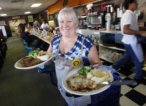 Al Hartmann  |  The Salt Lake Tribune
Server Jerri Reed brings out two of the daily specials to hungry customers at the Left Fork Grill in South Salt Lake. She holds a meatloaf special, left and chicken schnitzel, right. South Salt Lake has started its first-ever Restaurant Week, which ends Saturday.  Restaurants including the Left Fork Grill at 68 W. 3900 South are offering specials.