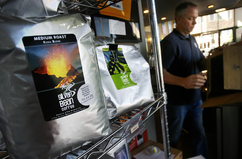 Scott Sommerdorf   |  The Salt Lake Tribune
Matt Happe works in his Silver Bean Coffee Company shop in Holladay, where has seen his business license fee of $200 increase to $700. Holladay city is cash-strapped but Happe believes this is bad for small businesses, Wednesday, Aug. 28, 2013.