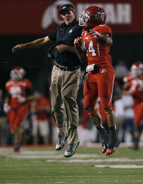 Scott Sommerdorf   |  The Salt Lake Tribune
Utah special teams coach Jay Hill air-bumps with RB Lucky Radley after Utah recovered an on-side kick. Utah beat Utah State 30-26, Thursday, August 29, 2013.