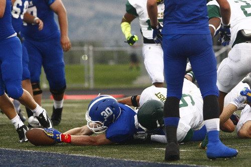 Chris Detrick  |  The Salt Lake Tribune
Bingham's Scott Nichols (30) dives short to the end zone while being tackled by Bonneville's Jayden Howell (9) during the game at Bingham High School Saturday August 24, 2013. Bingham is winning the game 14-7 at halftime.