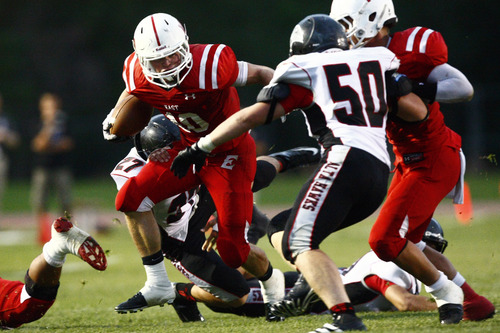 Chris Detrick  |  The Salt Lake Tribune
East's Preston Curtis (10) runs past Alta's Nathan Engstrom (27) and Paul Geilman (50) during the game at East High School Friday August 23, 2013. East is winning the game 21-10 at halftime.