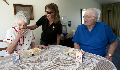 Steve Griffin  |  The Salt Lake Tribune
Doris and Art Smith laugh with Jodi Page Lasrich, of Meals on Wheels, while she delivers their lunch in their home in Cottonwood Heights, Utah Friday Aug. 29, 2013.