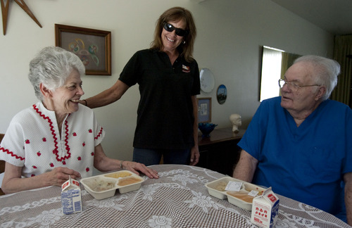 Steve Griffin  |  The Salt Lake Tribune
Doris and Art Smith chat with Jodi Page Lasrich, of Meals on Wheels, while she delivers their lunch in their home in Cottonwood Heights, Utah Friday Aug. 29, 2013.