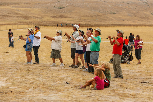 Trent Nelson  |  The Salt Lake Tribune
A group of kite-fliers work together during the Antelope Island Stampede, Saturday, August 31, 2013 at Antelope Island's White Rock Bay.