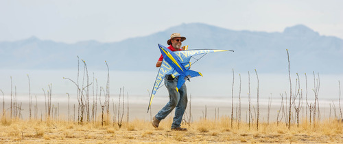 Trent Nelson  |  The Salt Lake Tribune
Dwain Hansen carries a kite during the Antelope Island Stampede, Saturday, August 31, 2013 at Antelope Island's White Rock Bay.